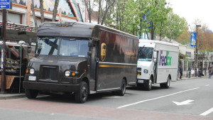 UPS - FedEx trucks delivering packages, packages
