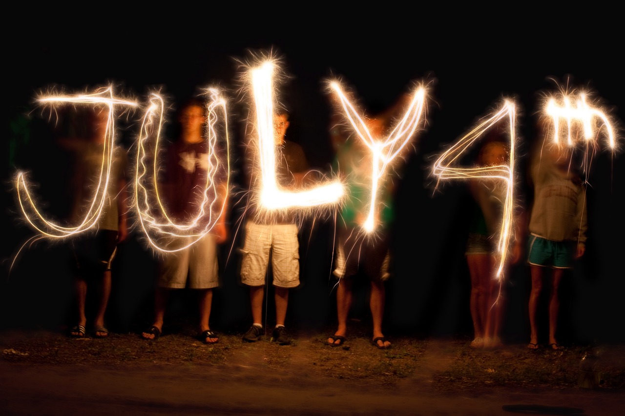 Young people are spelling out July 4th with sparklers
