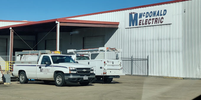 An electrical company building and trucks