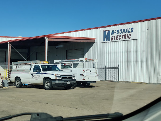 An electrical company building and trucks