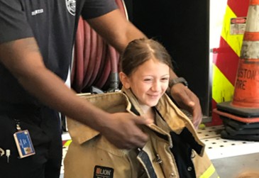 A firefighter teaching fire safety to children