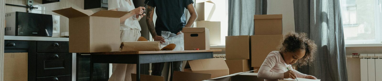family opening moving boxes