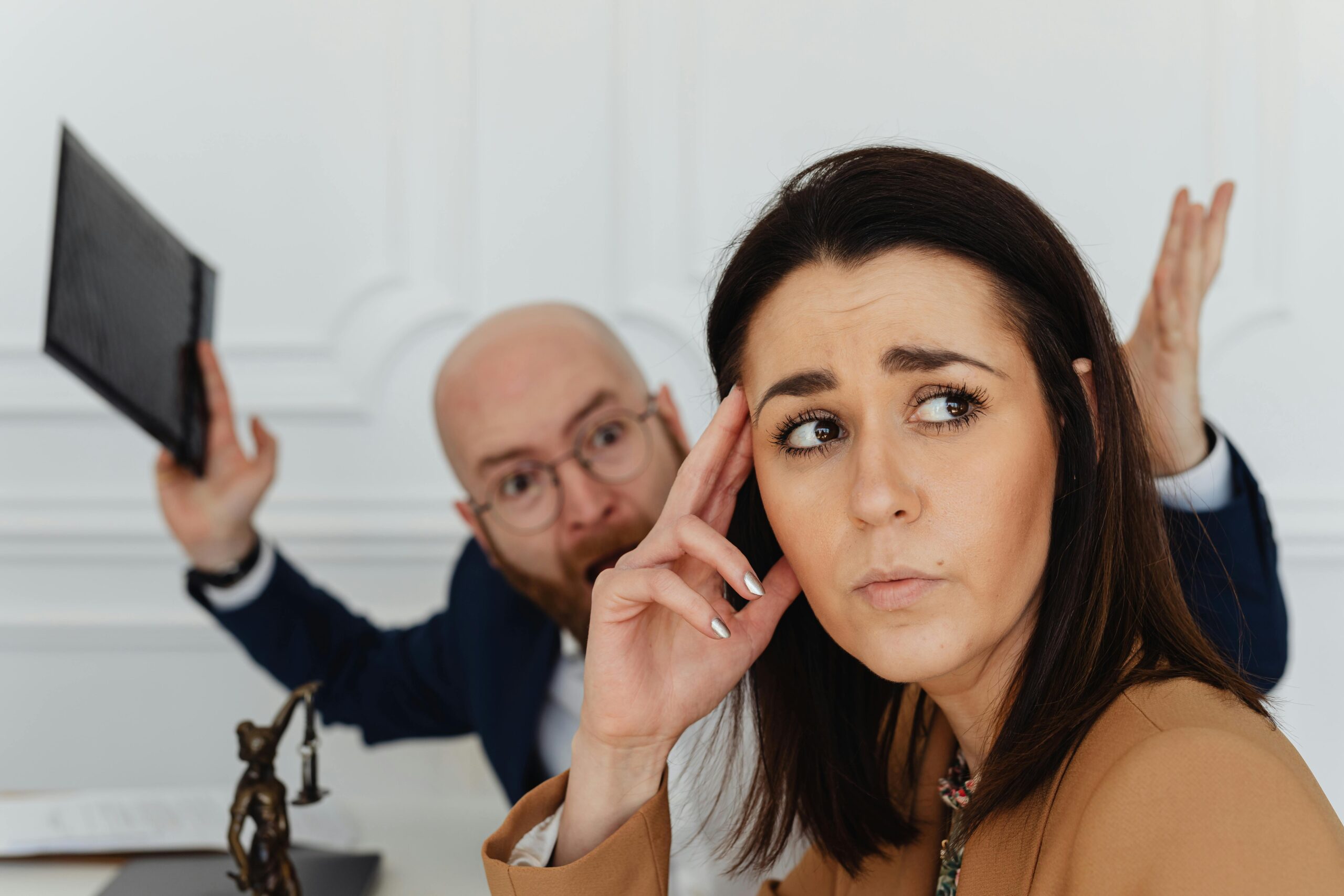 A man yelling at a woman in an office