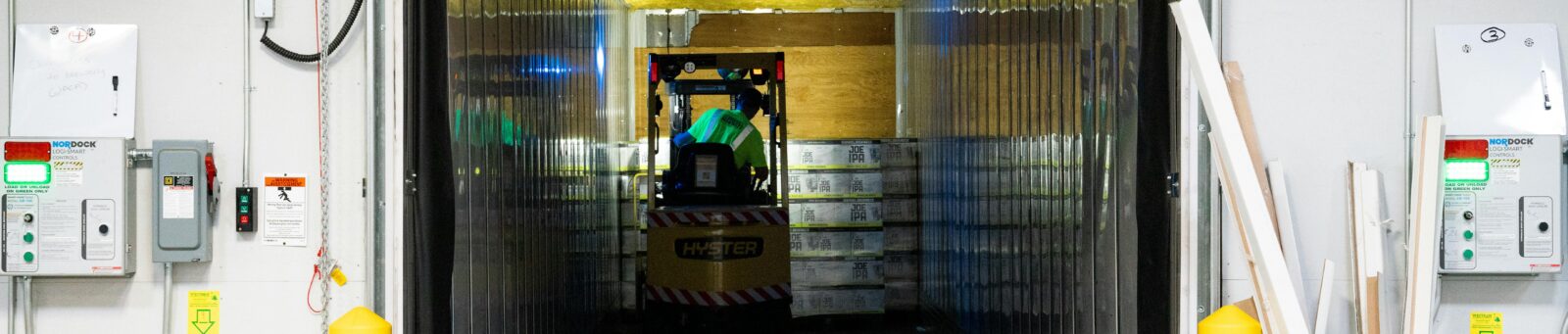 A loading dock with a forklift and packages