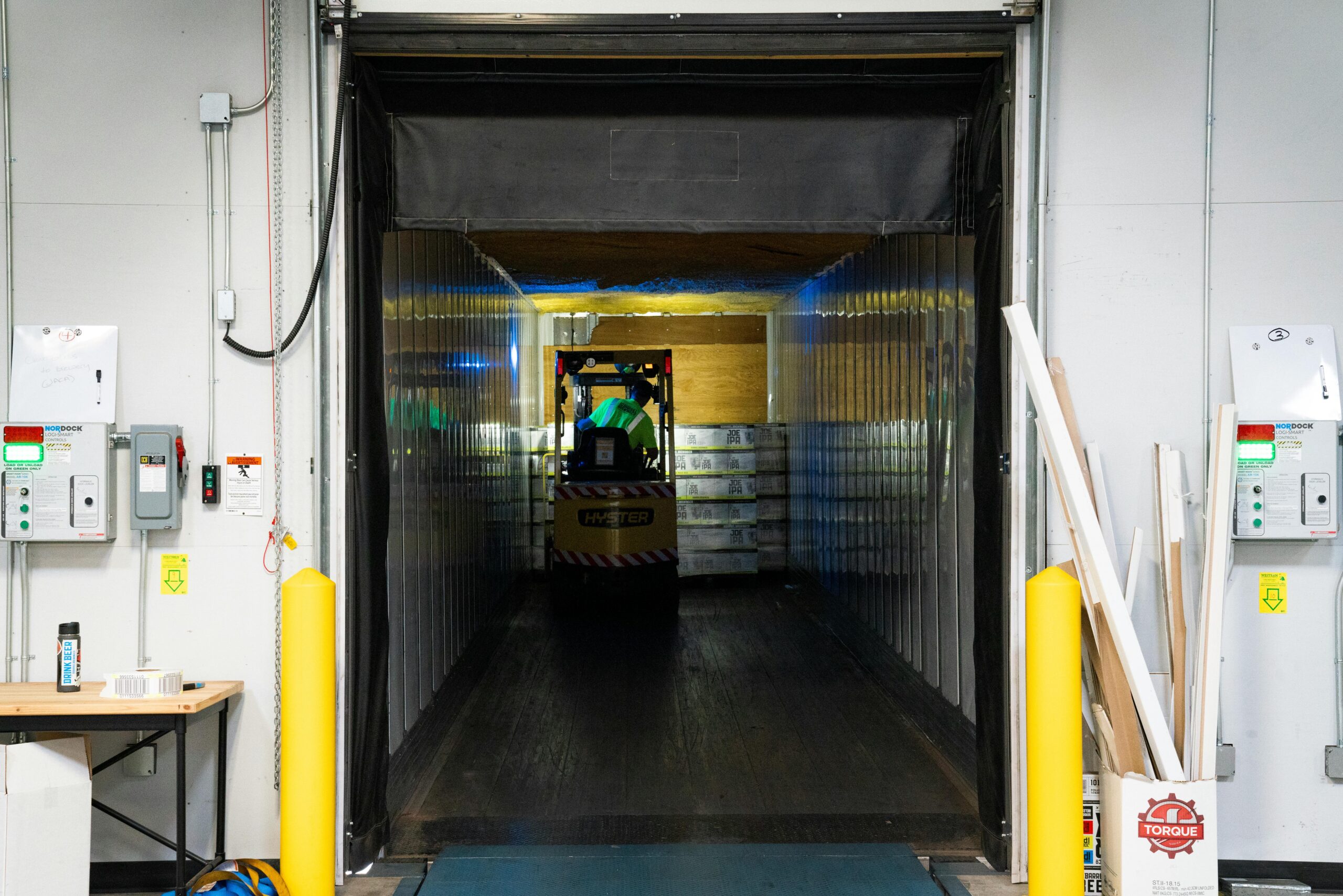 A loading dock with a forklift and packages