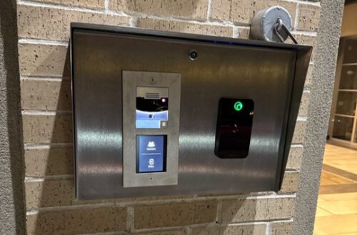 An intercom and access control reader at a building entry