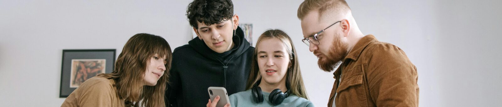 Parents and kids looking at alarm system app on phone