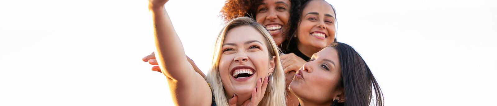 College girls taking a selfie and practicing spring break safety