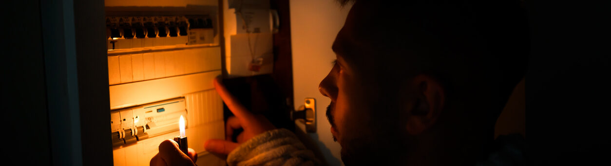 homeowner checking security system during power outage