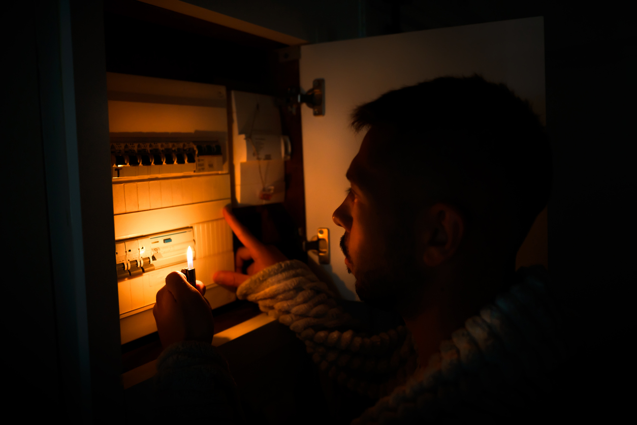 homeowner checking security system during power outage